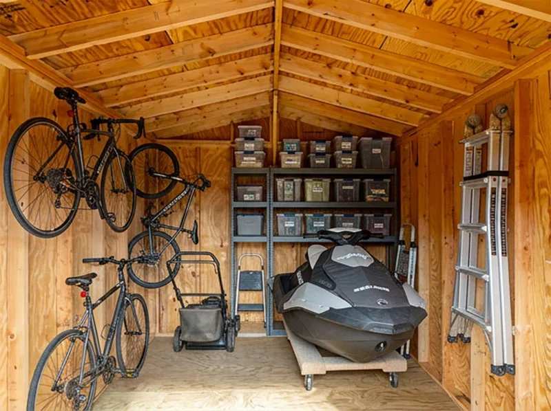 Fitted out for yard equipment, with a ride-on mower and tool storage